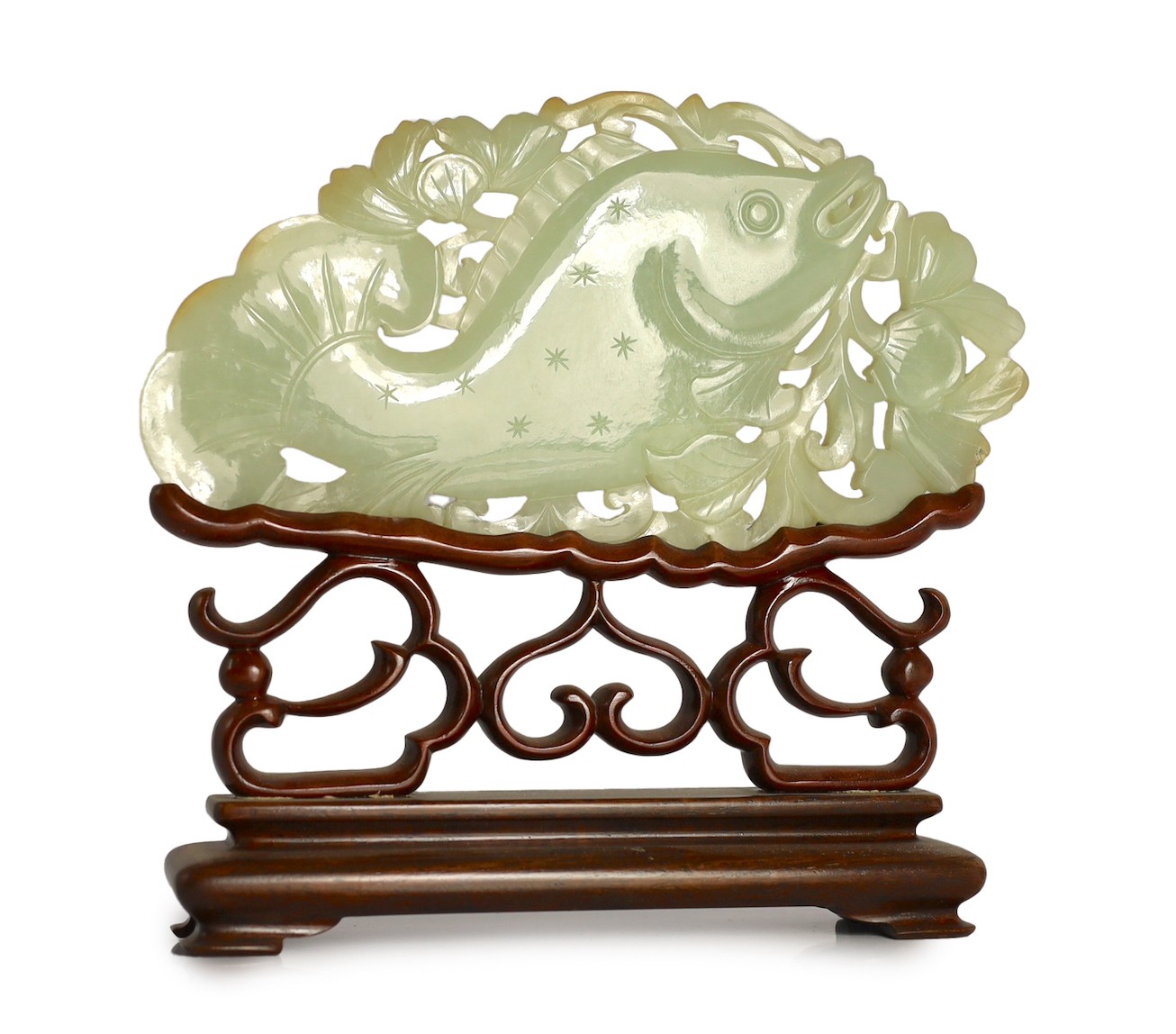 A Chinese pale celadon jade 'fish' plaque, 18th/19th century, 16.7cm long, 8.5cm high, later wood stand for use as a table screen